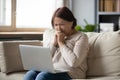 Sad mature woman looking at laptop screen and crying Royalty Free Stock Photo