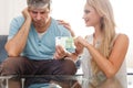 Sad man give 100 euros to gold digger blonde woman Royalty Free Stock Photo