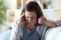 Sad middle age woman calling on phone at home Royalty Free Stock Photo