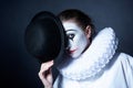 Sad mime Pierrot holding a black hat Royalty Free Stock Photo