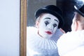 Sad mime Pierrot looking at the mirror Royalty Free Stock Photo