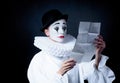 Sad mime Pierrot reading the love letter Royalty Free Stock Photo