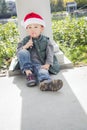 Sad Mixed Race Boy With Santa Hat and Candy Cane Royalty Free Stock Photo