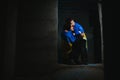 Sad mother hugging her son, both wearing Ukrainian national colors on black background