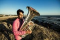 Sad musician play to Tuba on romantic sea shore. Royalty Free Stock Photo