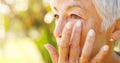 The sad nostalgia of passed youth. Closeup shot of a sad senior woman wiping tears off her face outdoors. Royalty Free Stock Photo