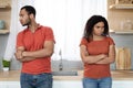 Sad offended young black man in red t-shirt ignores woman after quarrel, think about breakup Royalty Free Stock Photo