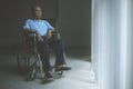 Sad old man sitting in a wheelchair Royalty Free Stock Photo