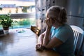 Sad old woman. Depressed lonely senior lady with alzheimer, dementia, memory loss or loneliness. Elder person looking out. Royalty Free Stock Photo