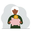 Sad old woman holds a piggy bank, a coin falls into the piggy bank. The concept of saving finance, savings, investing