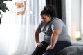 Sad overweight woman dreaming about slim body