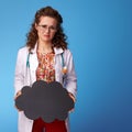 Sad paediatrist woman showing black cloud on blue