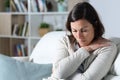 Sad pensive middle age woman looking down sitting at home Royalty Free Stock Photo