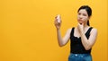 Sad pensive young asian woman holding money jar with savings. Low income and big expenditure concept Royalty Free Stock Photo