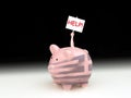 Sad piggy bank with the Greece flag with man inside holding up HELP! sign Royalty Free Stock Photo