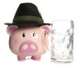 Sad piggy bank wearing beer festival hat and empty pint