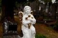 Sad porcelain angel with golden wings (Campo Santo, Sint-Amandsberg)