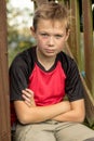 Sad pre-teen boy sitting outside Royalty Free Stock Photo