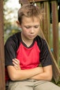 Sad pre-teen boy sitting outside Royalty Free Stock Photo