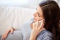 Sad pregnant woman calling on smartphone at home Royalty Free Stock Photo