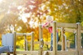 Sad preschooler boy bored on outdoor playground at autumn. Lonely during quarantine. Child can`t play with friends while Royalty Free Stock Photo