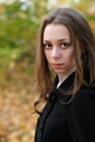 Sad pretty girl in fall park Royalty Free Stock Photo