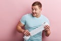 Sad scared fearful young man holding a roll of toilet paper Royalty Free Stock Photo