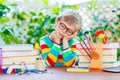 Sad school kid boy with glasses and student stuff Royalty Free Stock Photo