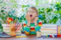 Sad school kid boy with glasses and student stuff Royalty Free Stock Photo