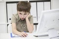 Sad schoolboy does homework. Royalty Free Stock Photo