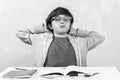 Sad schoolboy doing homework. Tired schoolboy sitting at table Royalty Free Stock Photo