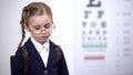 Sad schoolgirl in broken glasses feels insecure, bullied by peers for spectacles