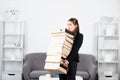 Sad secretary girl holding many folders with the documents, stressed overworked businesswoman too much work, office Royalty Free Stock Photo