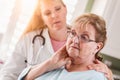 Sad Senior Adult Woman Being Consoled by Female Doctor or Nurse