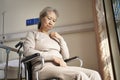 Sad senior asian woman sitting in wheelchair in nursing home Royalty Free Stock Photo