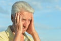 Sad senior man against blue cloudy sky Royalty Free Stock Photo