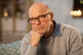 Sad senior man in glasses thinking at home Royalty Free Stock Photo