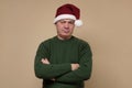 Sad senior man in santa hat looking angry. Royalty Free Stock Photo