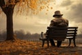 Sad senior man sitting alone on a bench in city park on autumn day. Elderly man enjoying nice fall weather