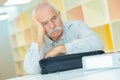 Sad senior man sitting at table at office Royalty Free Stock Photo