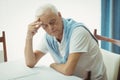 Sad senior man sitting at table Royalty Free Stock Photo