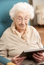 Sad Senior Woman Looking At Photograph Royalty Free Stock Photo