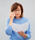 Sad senior woman reading letter and crying Royalty Free Stock Photo