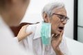 Sad senior woman suffers from illness,toothache and tooth decay,elderly people having hypersensitive teeth,painful,problem during