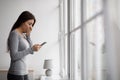 Sad shocked upset scared european millennial woman reading message on phone with bad news at home Royalty Free Stock Photo