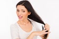 Sad shoked young woman cutting her long hair Royalty Free Stock Photo