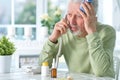 Sad sick senior man posing at home and calling doctor Royalty Free Stock Photo