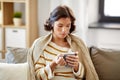 Sad sick young woman drinking hot tea at home