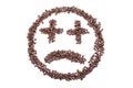 Sad smiley from coffee beans, isolated on white background