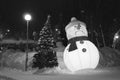 Sad snowman with a Christmas tree